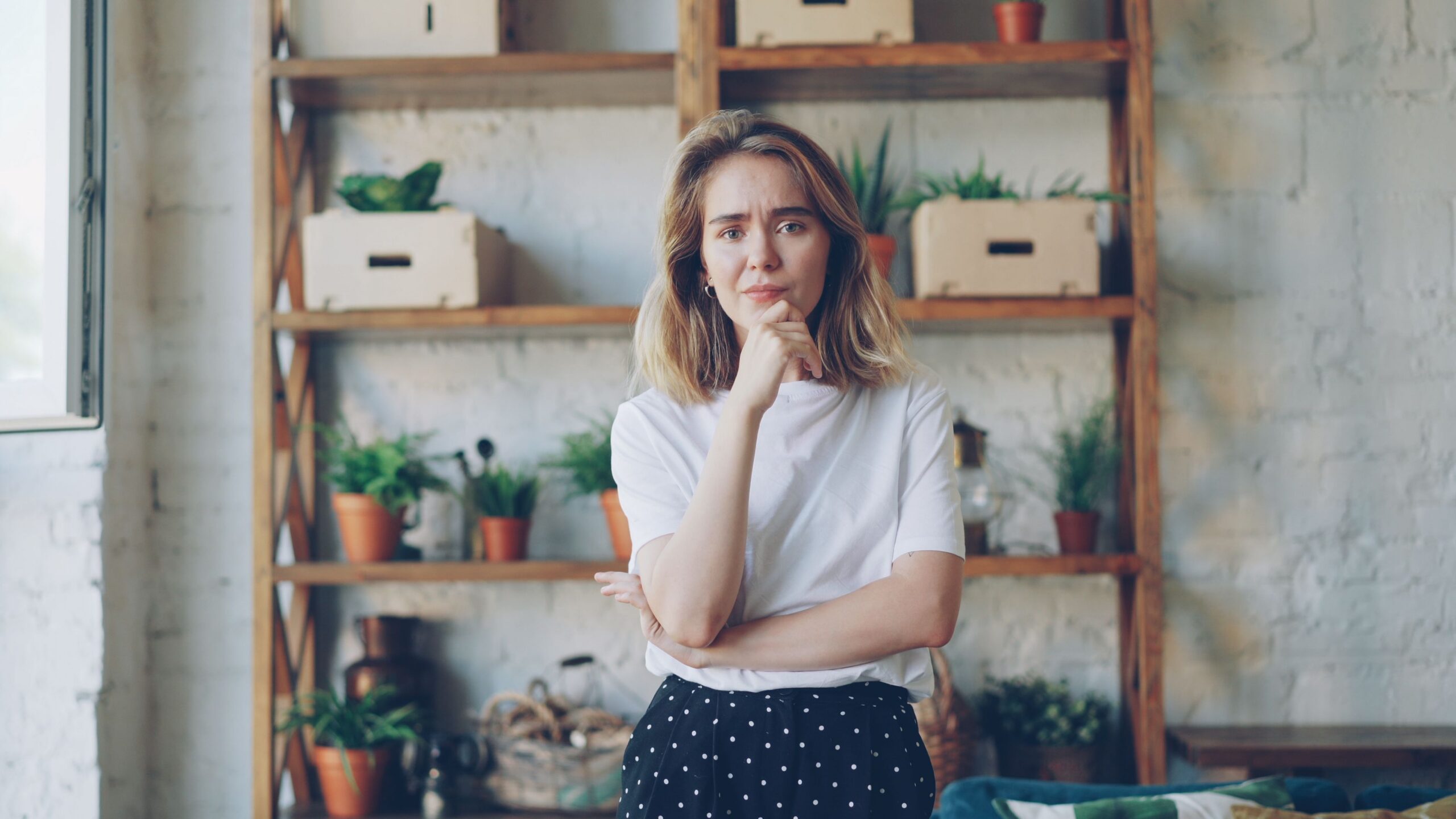 A thoughtful woman reflecting on how to find a trauma-informed doctor for medical self-advocacy.
